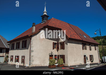 Haus mit kleinen Turm und blauen sonnigen Himmel im Dorf Thorens-Glieres. Im Departement Haute-Savoie, Frankreich. Stockfoto