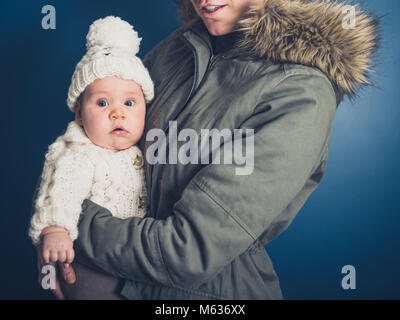 Eine junge Mutter und Baby im Winter Kleidung Stockfoto