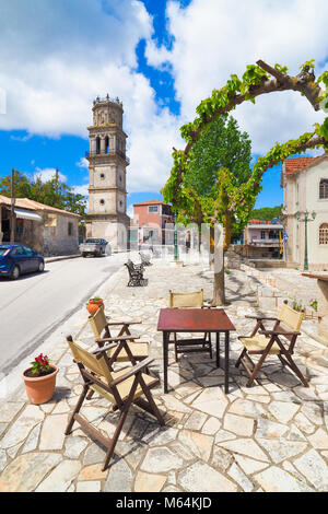 Traditionelles griechisches Dorf auf der Insel Zakynthos mit Tisch und Stühlen vor der Taverne in Westgriechenland Stockfoto