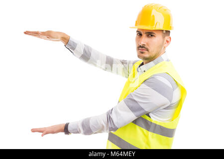 Junge schöne Konstruktor Holding leere Raum und Textbereich Vorlage auf weißem Hintergrund Stockfoto