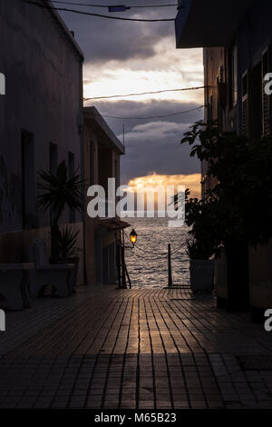 Gasse, die zum Meer bei Sonnenuntergang in Puerto de Santiago, Teneriffa, Kanarische Inseln, Spanien Stockfoto