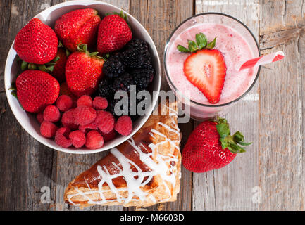 Gesundes Essen und leckeres Frühstück. Frische Beeren und Erdbeeren Milchshakes in einem Glas Stockfoto
