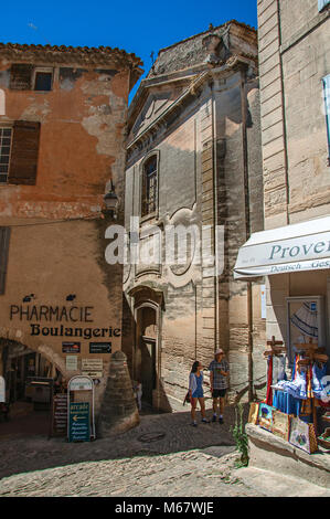 Blick auf die Gassen mit Geschäften und Kirche im historischen und wunderschönen Stadt Zentrum von Gordes. In der Region Provence, Südfrankreich. Stockfoto