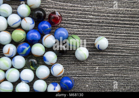 Ein Baby spielen mit Glasmurmeln, farbigem Glas Marmor, Hunderte von bunten Glasmurmeln, Stockfoto