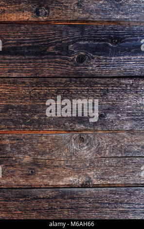 Vertikale dekorativen Hintergrund mit Textur von alten, dunklen Holz- Geteerten Brettern Stockfoto