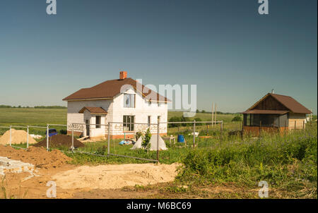 Bau des neuen Cottage aus weissem Stein auf Hintergrund blauer Himmel Stockfoto