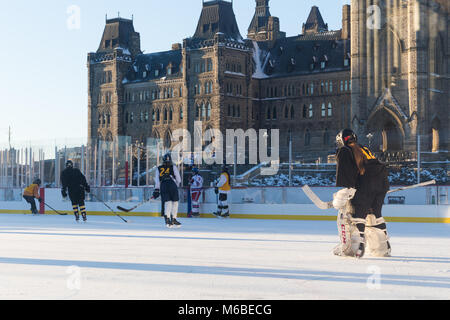 Ottawa, Kanada - 16. Dezember 2017: Mädchen spielen Hockey an der temporäre Eislaufbahn auf dem Parliament Hill Stockfoto