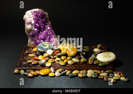 Amethyst Kristall und bemalten Steinen mit Om Symbol Stockfoto