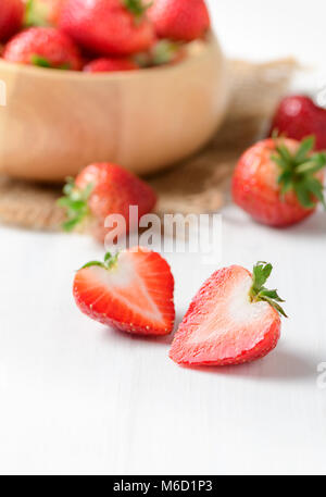 fresh sliced Red berry strawberries on white  wood background, diet fruits concept Stockfoto