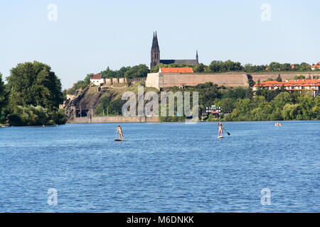 Prag, tschechische Republik - 19 AUGUST 2012: Frau Segeln auf standup paddleboard auf der Moldau mit Vysehrad im Hintergrund Am 19. August 2012 in Prag Stockfoto