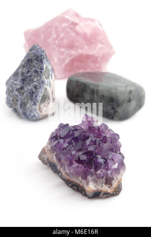 Große Kristall Steine, Edelsteine, vier verschiedene Arten, verarbeitete und unverarbeitete, auf weißem Hintergrund Stockfoto