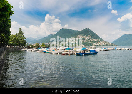 Lugano city, lake Lugano, Switzerland. Gulf of Lugano, Lugano lakeside promenade and Bre mountain on a beautiful summer day Stockfoto