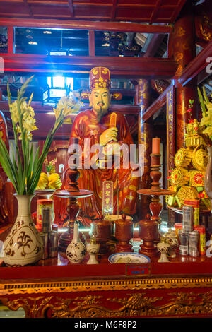 Altar beladen mit Geschenken, Blumen und Geld in den Tempel der Literatur in Hanoi, Vietnam Stockfoto