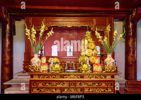 Altar beladen mit Geschenken, Blumen und Geld in den Tempel der Literatur in Hanoi, Vietnam Stockfoto