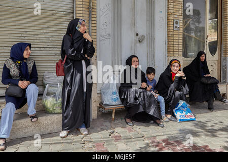 Kashan, Iran - 27. April 2017: Eine Gruppe von muslimischen Frauen an der Bushaltestelle wartet auf den städtischen Bus. Stockfoto