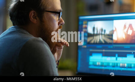 Männliche Video Editor arbeitet mit Film und Sound auf seinem PC. Er arbeitet in einem kühlen Büro Loft. Stockfoto