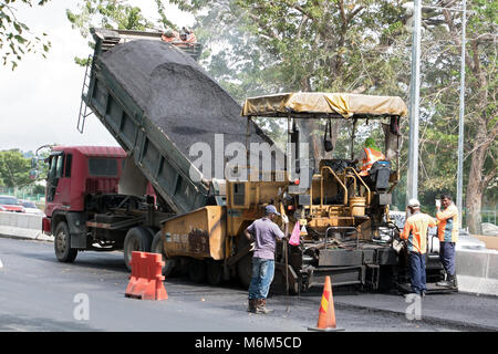 PENANG, MALAYSIA, 10.November 2017, den Asphalt Maschine setzt eine neue Oberfläche - Schicht auf der Straße. Eine belagserneuerung Bau von Straßen. Stockfoto