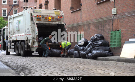 Brooklyn, NY - 7. Juni 2016: DSNY Arbeiter sammeln Müll auf einer Straße der Stadt. New York Abteilung der Hygiene ist für Abfall und Recycling co verantwortlich. Stockfoto