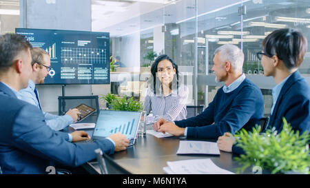 Chief Führungskraft gibt einen Bericht an Ihre Kollegen im Saal. Team verschiedener Intelligente Leute Hört sorgfältig. Modernes Büro Stockfoto