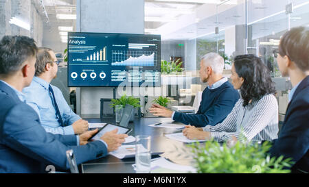 Der Verwaltungsrat hat die Hauptversammlung, vielfältige Gruppe von Geschäftsleuten in den modernen Konferenzraum diskutieren Statistiken und Arbeitsergebnisse. Stockfoto