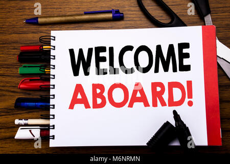 Handschriftlichen Text, Willkommen an Bord. Business Konzept für Gruß melden Sie Mitglied auf dem Notebook geschrieben, Holz- hintergrund Bürogeräte wie Stifte s Stockfoto