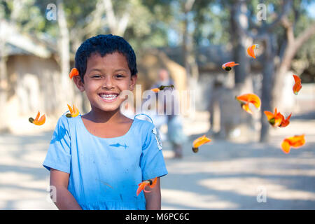 School Girl holding Butea monosperma palash (Blume) in Bogra District, Bangladesch. Stockfoto