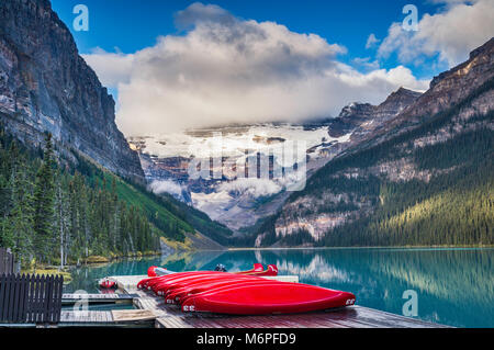 Mount Victoria in Wolken über Lake Louise, rot Kanus auf Deck, kanadischen Rocky Mountains, Banff National Park, Alberta, Kanada Stockfoto