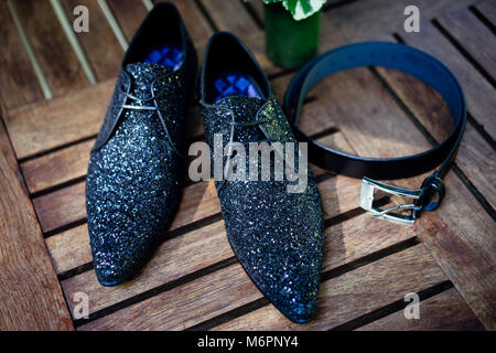 Die glitzernden Schuhe für Herren mit den Riemen auf den Holztisch - Ansicht von oben, geschlossen Stockfoto