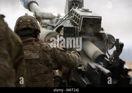 Us-Soldaten von Alpha Batterie, 4-319 th Airborne Field Artillery Regiment, 173Rd Airborne Brigade ein Brand Mission während der Übung dynamische Vordere 18 an der 7. Armee Befehl in Grafenwöhr, Deutschland, 5. März 2018 ausgeführt werden. Übung dynamische Vordere 18 enthält ca. 3.700 Teilnehmer aus 26 Nationen in der US-Armee Grafenwöhr Training Area (Deutschland), 24.02.23. - 10. März 2018. Dynamische Vordere ist eine jährliche US-Army Europe (USAREUR) Übung konzentriert sich auf die Interoperabilität der US-Armee, gemeinsame Service- und Alliierten nation Artillerie und Feuer in einer multinationalen Umgebung, in Th Stockfoto