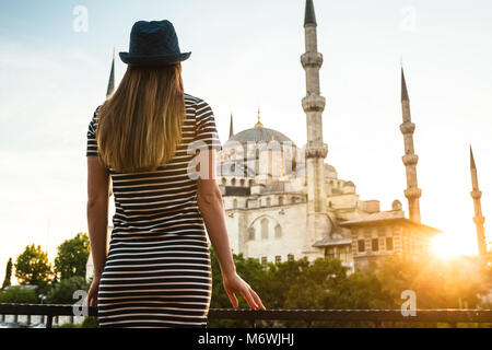 Ein junger Tourist Mädchen mit einem schönen Bild sieht von der Terrasse des Hotels auf der ganzen Welt berühmten Blauen Moschee Sultanahmet in Istanbul, Türkei. Reisen, sig Stockfoto