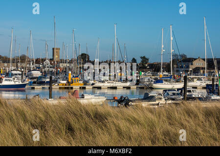 Das Dorf von Yarmouth auf der Isle of Wight mit Yachten vor Anker und im Hafen und Schilf mit Dünen im Vordergrund Anker. Isle of Wight Küste Stockfoto