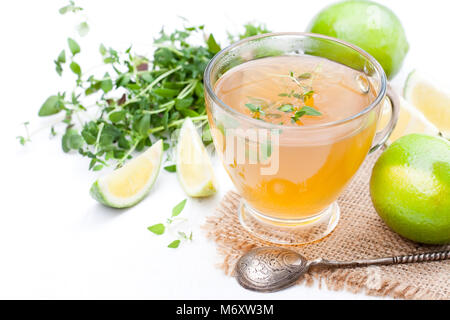 Grüner Tee mit Thymian und Kalk auf weißem Hintergrund Stockfoto