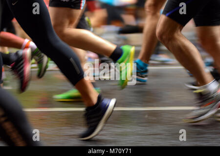 Beine des Männlichen und weiblichen Läufer auf dem Asphalt. Marathon Stockfoto