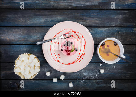 Caramel Käsekuchen mit Erdbeeren auf dem hölzernen Hintergrund der Ansicht von oben Stockfoto