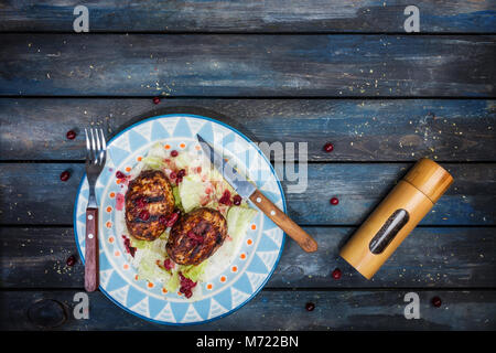 Türkei Schnitzel mit frischen Beeren und saucea Eisberg Salat mit Besteck und Pepper Grinder serviert. Stockfoto