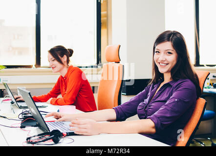 Erfolgreiche hübsche junge Businesswomans im Büro Stockfoto