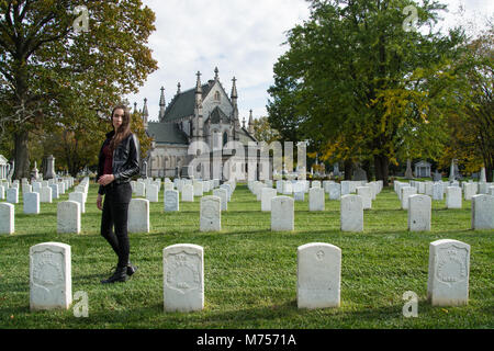 Memorial Day. Ein junges Mädchen achtet das Zahlen für Soldaten, die gekämpft haben und gestorben sind Freiheit, Grabsteine im Crown Hill Cemetery, Indianapolis, Indiana Stockfoto