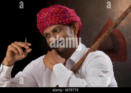 Landwirt tragen von Turban und Rauchen Zigarre Stockfoto