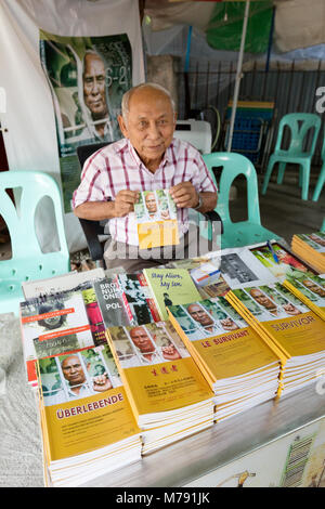 Chum Mey, einer von nur 7 bekannten Überlebenden der Roten Khmer Tuol Sleng S-21 Camp, am Tuol Sleng, den Verkauf seiner Autobiographie; Phnom Penh, Kambodscha, Asien Stockfoto