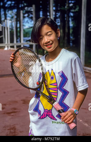 Porträt einer jungen asiatischen Mädchen ihren Tennisschläger Holding im Summer Camp in Vermont. Stockfoto