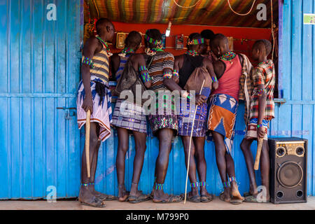 Junge Hamar Männern außerhalb ein Mobiltelefon (Handy) Shop während Ihrer wöchentlichen Besuch der Stammes- Markt in Dimeka, Omo Valley, Äthiopien Stockfoto