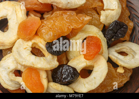 Gesundes Essen. Mix aus getrockneten Früchten in einem irdenen Schüssel - Äpfel, Birnen, Pflaumen, Aprikosen, close-up. Selektiver Fokus Stockfoto