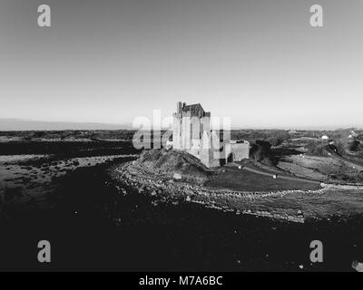 Schwarze und weiße Dunguaire Castle Schloss Sonnenuntergang am Abend, in der Nähe von Kinvarra in der Grafschaft Galway, Irland - wilden Atlantischen Strecke. Berühmte öffentliche touristische Anziehung, die ich Stockfoto