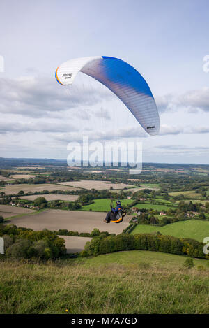 Gleitschirm über der nach Norden ausgerichteten escarpment Steigung auf Harting, West Sussex, UK fliegen. South Downs National Park. Paragliding. Harting Hill Stockfoto