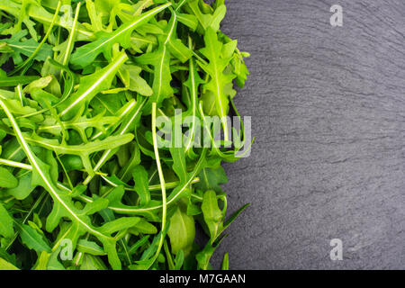 Frisches Grün Rucola auf schwarzem Hintergrund Stockfoto