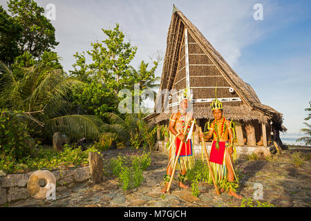 Diese zwei Jungen in traditionellen Outfits für kulturelle Zeremonien stehen vor ein Haus auf der Insel Yap in Mikronesien. Stockfoto