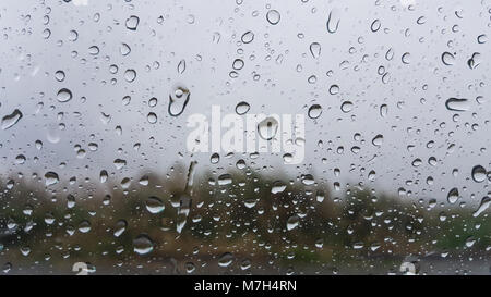 Regnerischen Tag, Regen fällt die Anzeige auf dem Fenster. Stockfoto