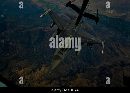 Ein US Air Force F-16 Fighting Falcon in die 455Th Air Expeditionary Wing, Flughafen Bagram, Afghanistan zugewiesen erhält Kraftstoff über Afghanistan von einer KC-10 Extender, 9. März 2018. Die F-16 bietet Abdeckung von oben für die afghanischen und die Streitkräfte der Koalition auf dem Boden, die Abschreckung der aufständischen Aktivität und freundlich die Freizügigkeit der Truppen. (U.S. Air Force Foto von Tech. Sgt. Anthony Nelson Jr.) Stockfoto