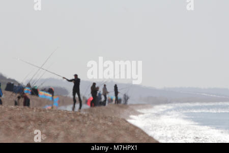 Angler in der Heat Haze an einem heißen Tag am Chesil Beach UK, meist Makrelenfangs Stockfoto