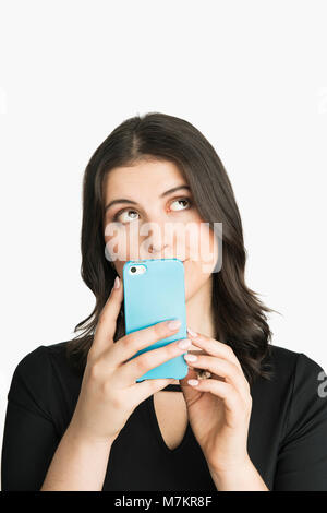 Eine Frau mit Ihrem Smart Device und nachdenklich. Stockfoto